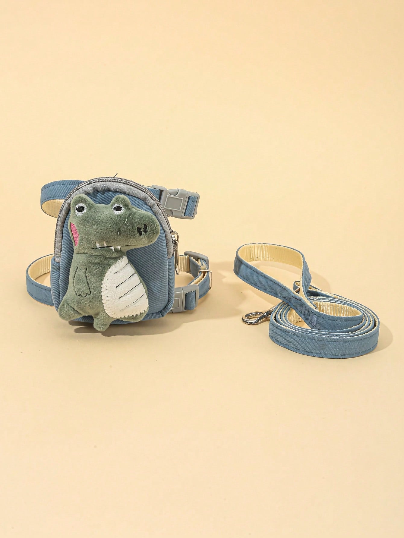 Multicolor plush dinosaur decor pet backpack with collar, harness and leash set for cats and small dogs, designed to carry food or poop bags.