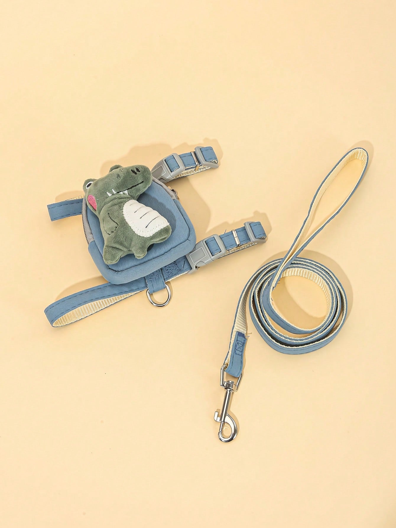Multicolor plush dinosaur decor pet backpack with collar, harness and leash set for cats and small dogs, designed to carry food or poop bags.