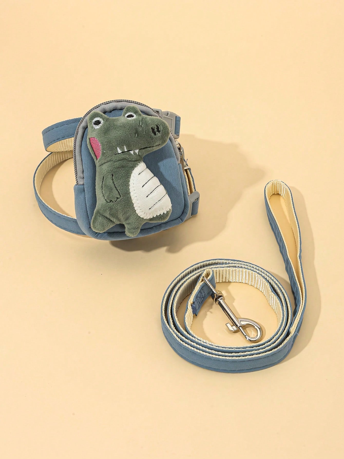 Multicolor plush dinosaur decor pet backpack with collar, harness and leash set for cats and small dogs, designed to carry food or poop bags.
