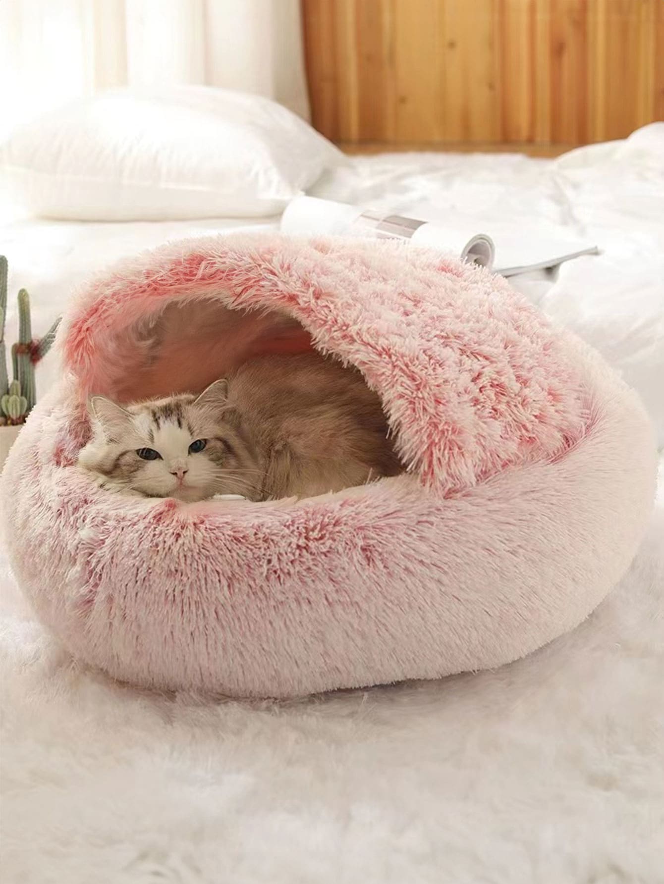 Pink plush round donut pet bed cushion for cats and dogs made from soft polyester fabric.