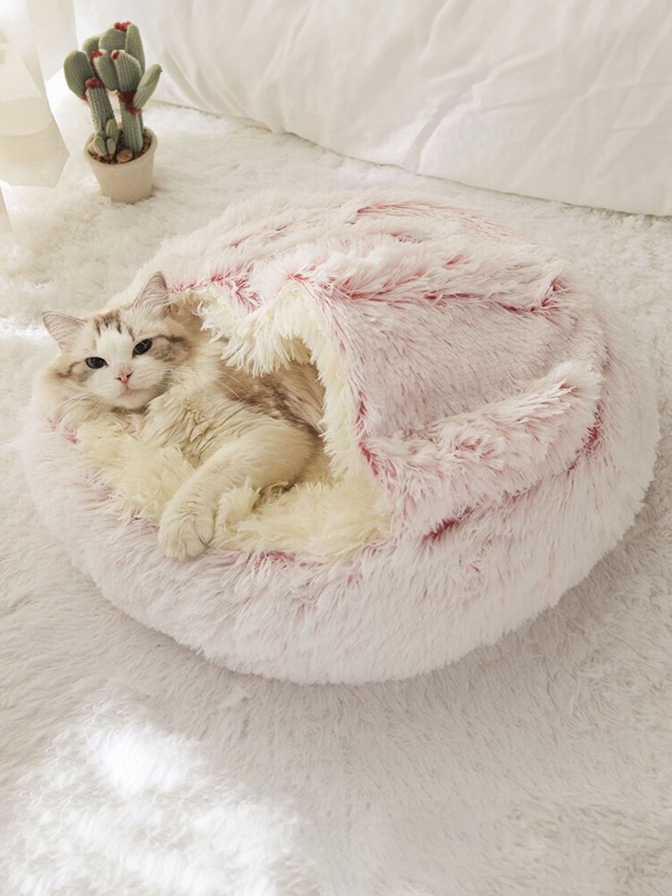 Pink plush round donut pet bed cushion for cats and dogs made from soft polyester fabric.