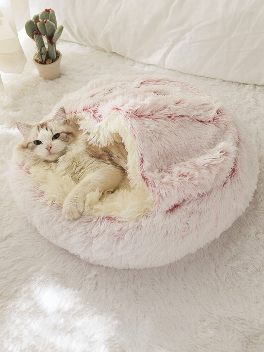 Pink plush round donut pet bed cushion for cats and dogs made from soft polyester fabric.