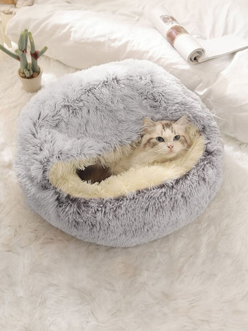 Pink plush round pet bed with a soft 2-in-1 donut sleeping bag cushion design for cats and dogs.
