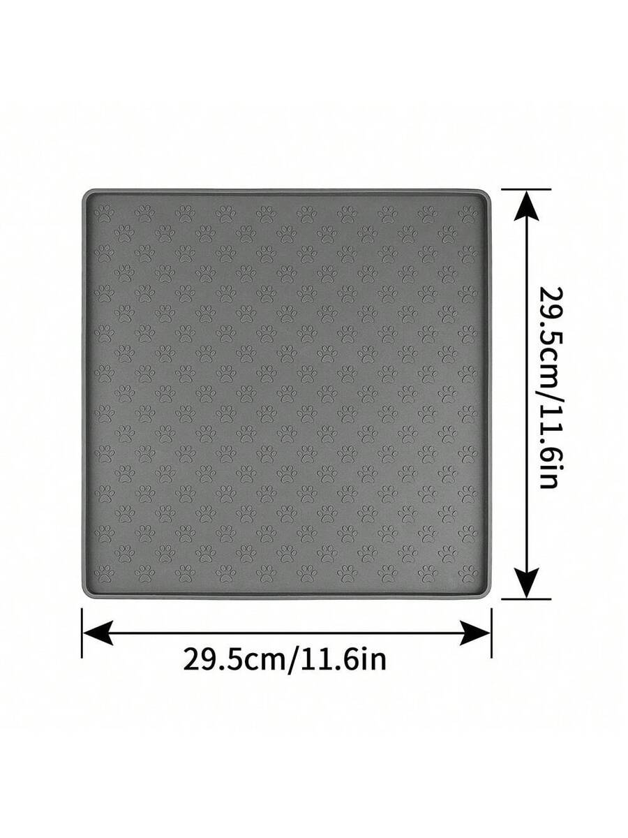 Beige silicone pet placemat with embossed paw print accents designed to catch food and water spills for dogs and cats.