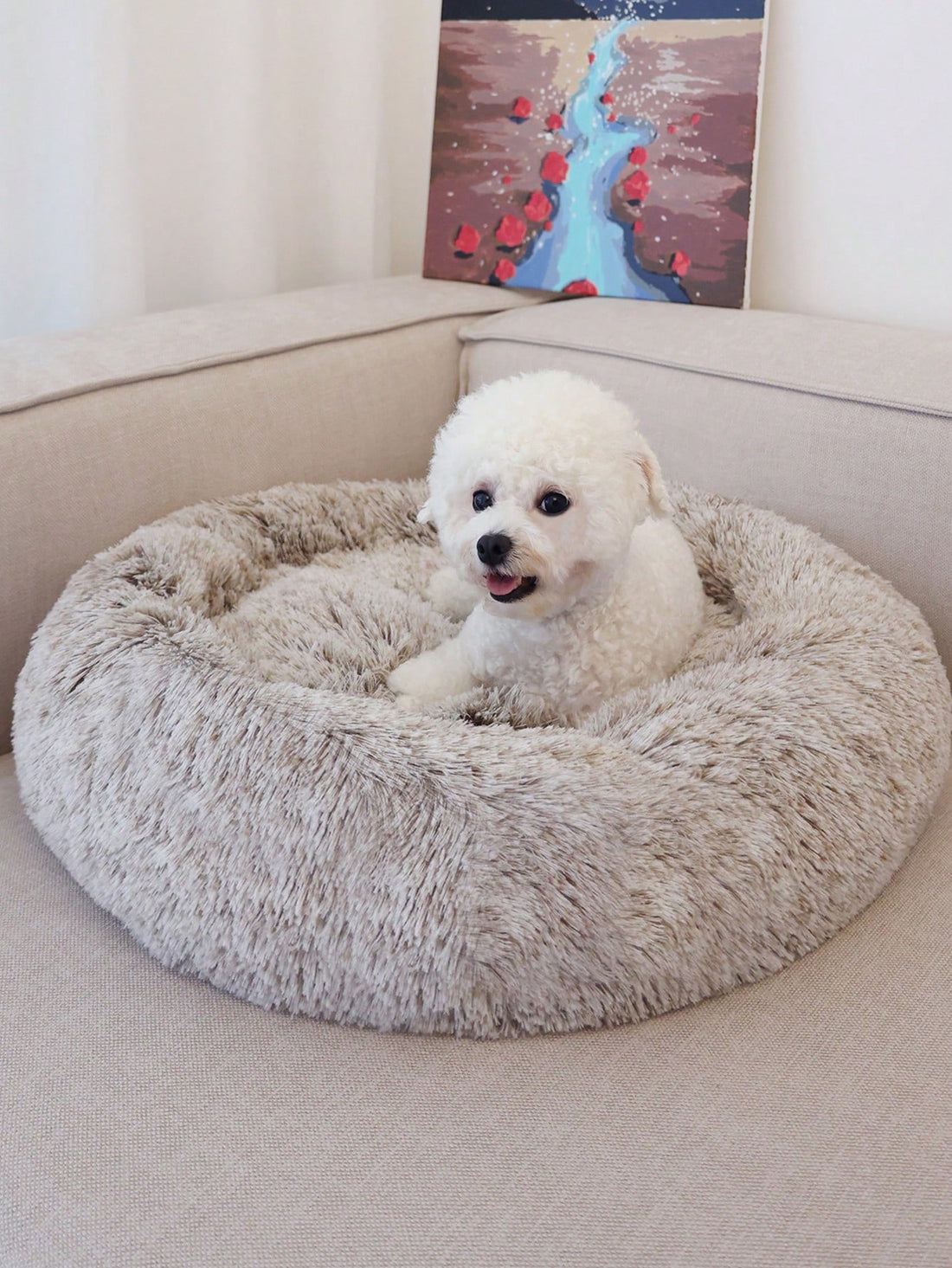 Champagne plush round pet bed for small and medium cats and dogs made from soft polyester material.