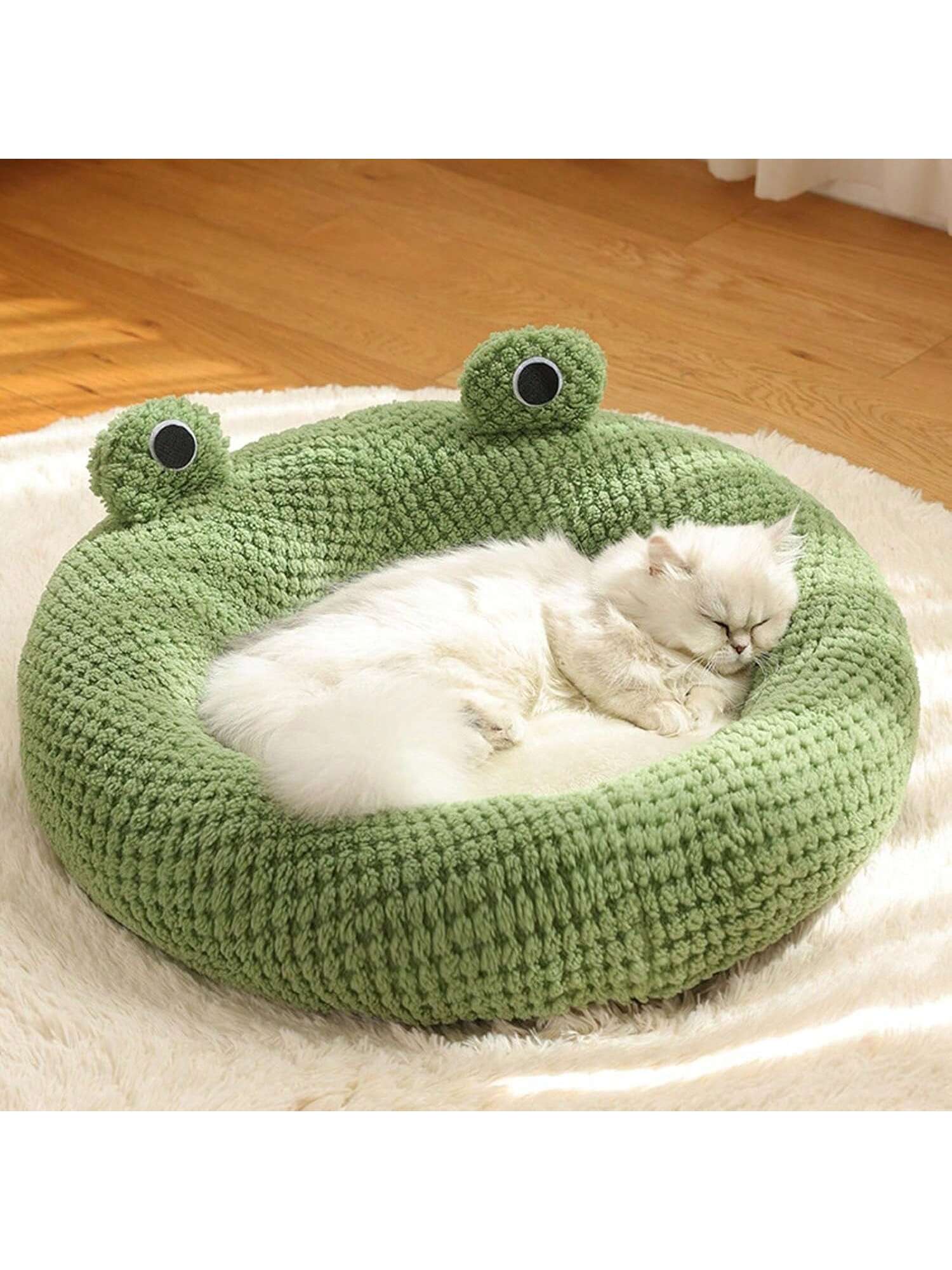 Mint green round plush pet bed featuring an open warm nest design for cats and small dogs.