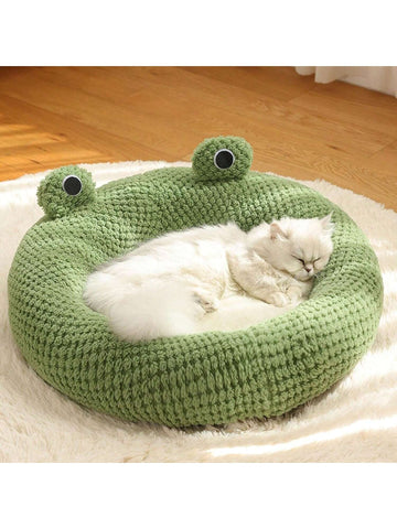 Mint green round plush pet bed featuring an open warm nest design for cats and small dogs.