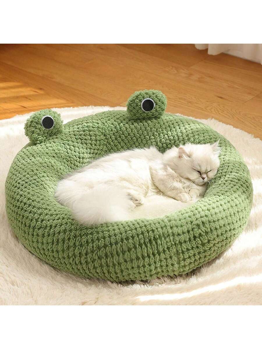 Mint green round plush pet bed featuring an open warm nest design for cats and small dogs.