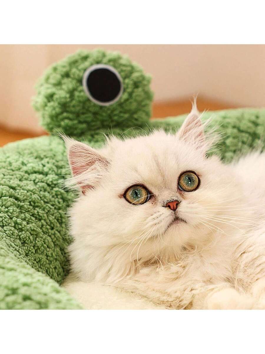 Mint green round plush pet bed featuring an open warm nest design for cats and small dogs.
