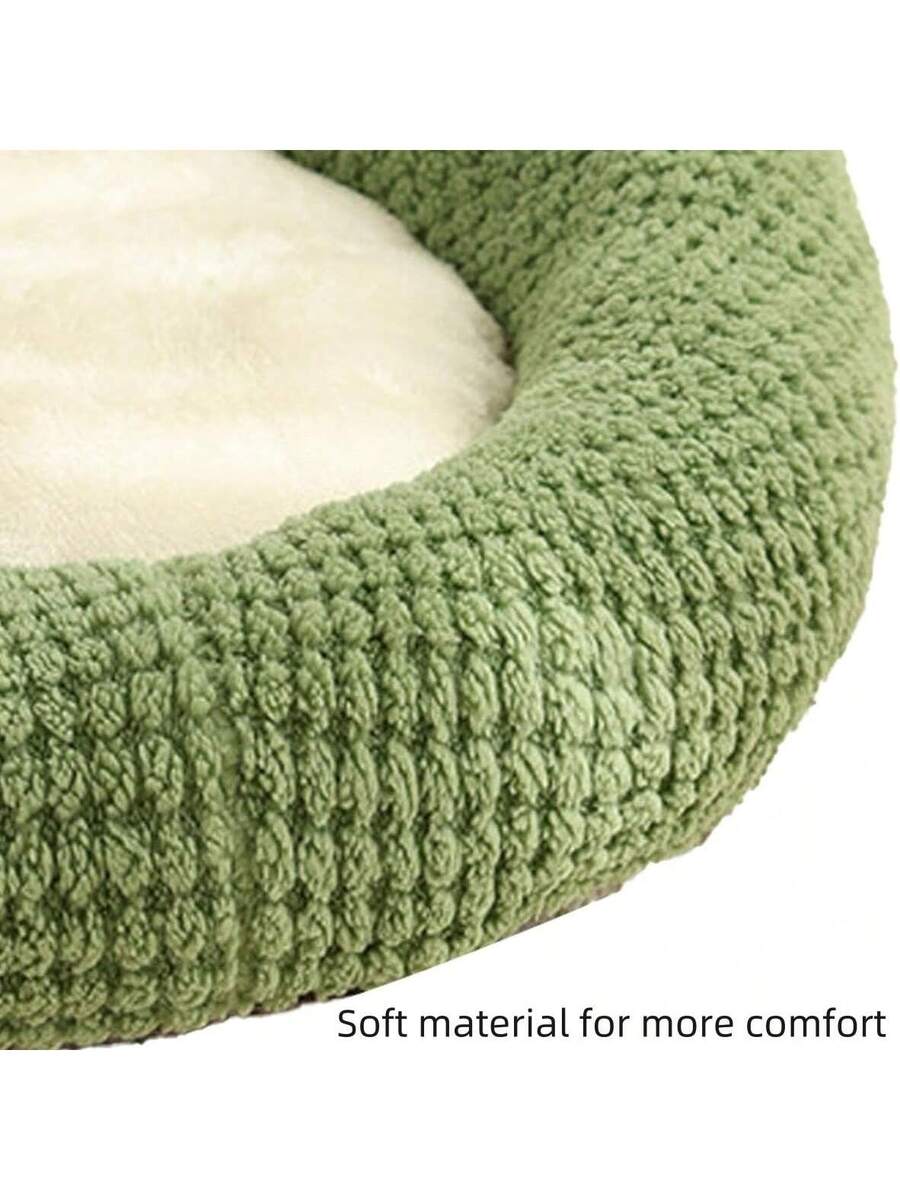 Mint green round plush pet bed featuring an open warm nest design for cats and small dogs.