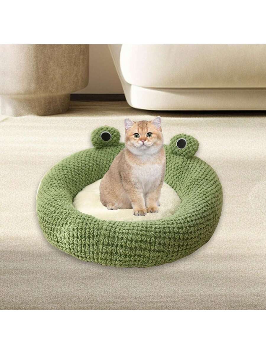 Mint green round plush pet bed featuring an open warm nest design for cats and small dogs.