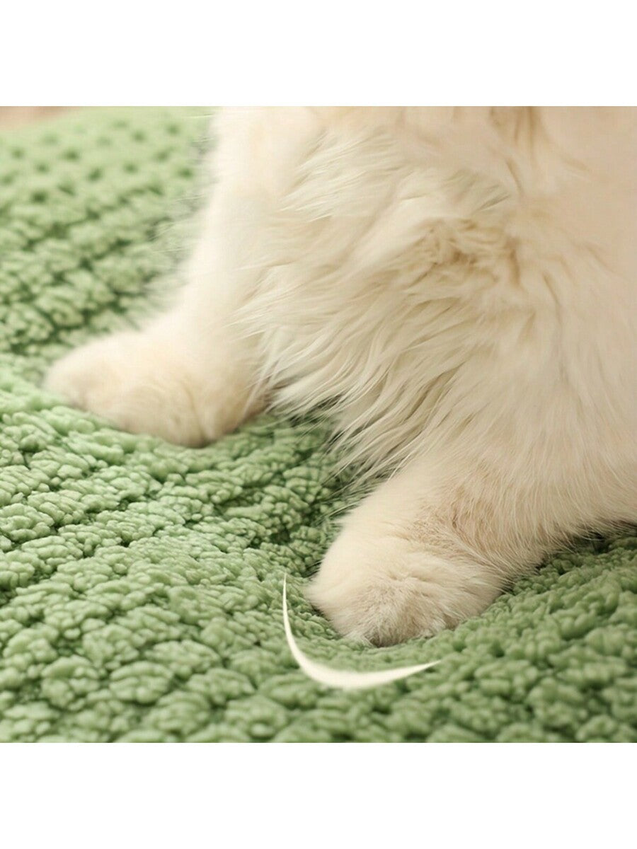 Mint green round plush pet bed featuring an open warm nest design for cats and small dogs.