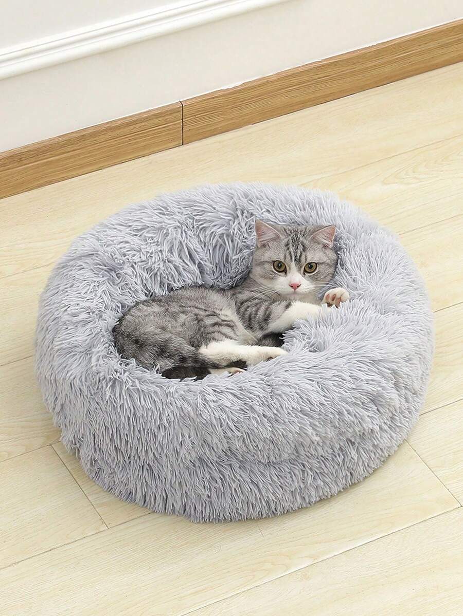 Grey fluffy round pet bed made with 100% polyester fabric and filling for cats and dogs.
