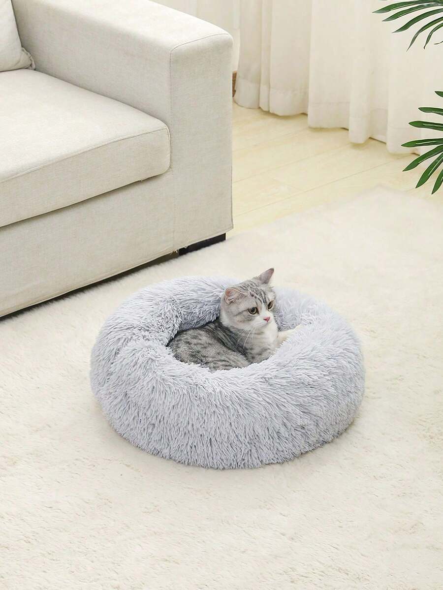 Grey fluffy round pet bed made with 100% polyester fabric and filling for cats and dogs.
