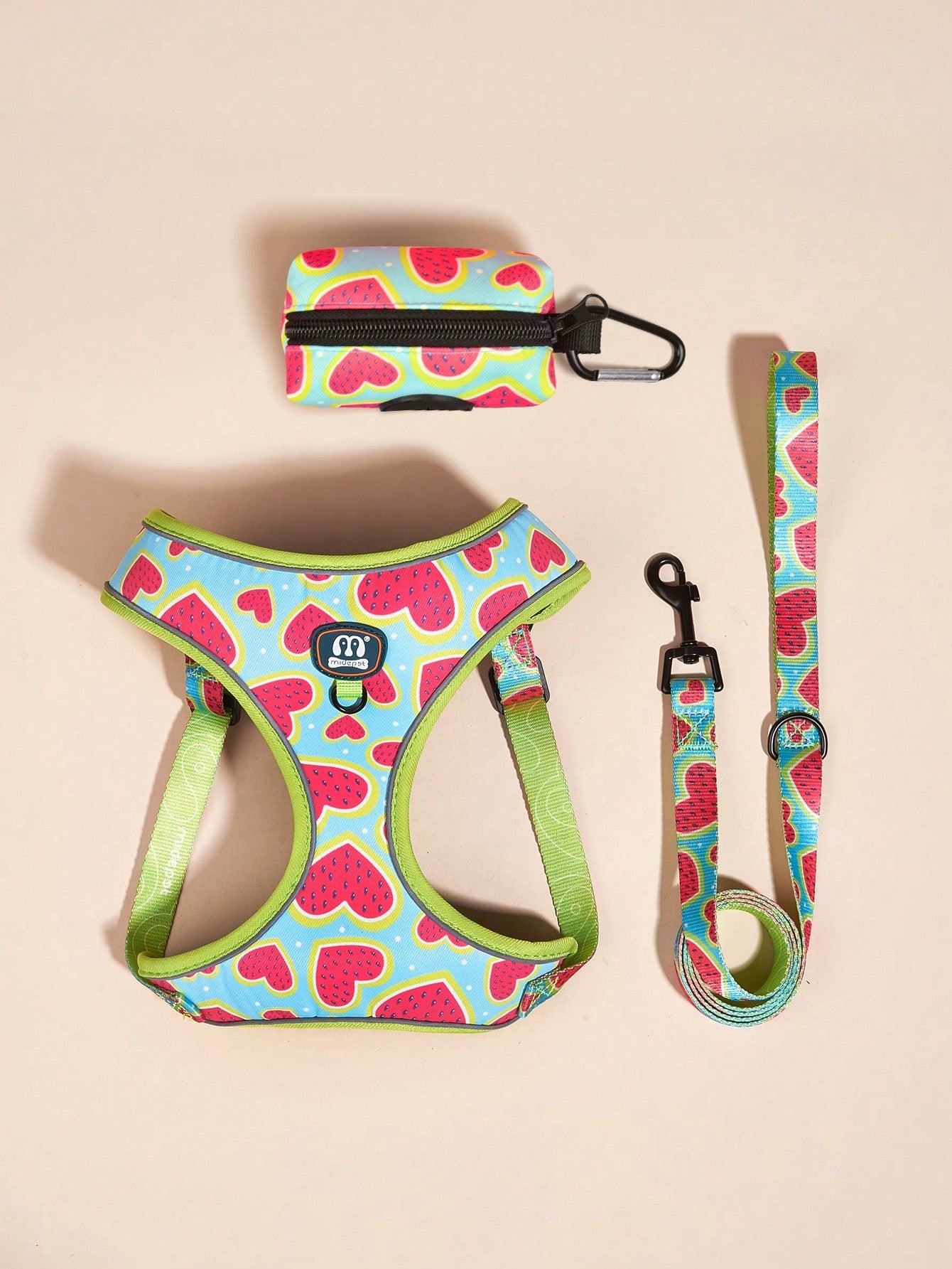 Hot pink heart print adjustable dog harness and leash set with matching poop bag holder for outdoor walking