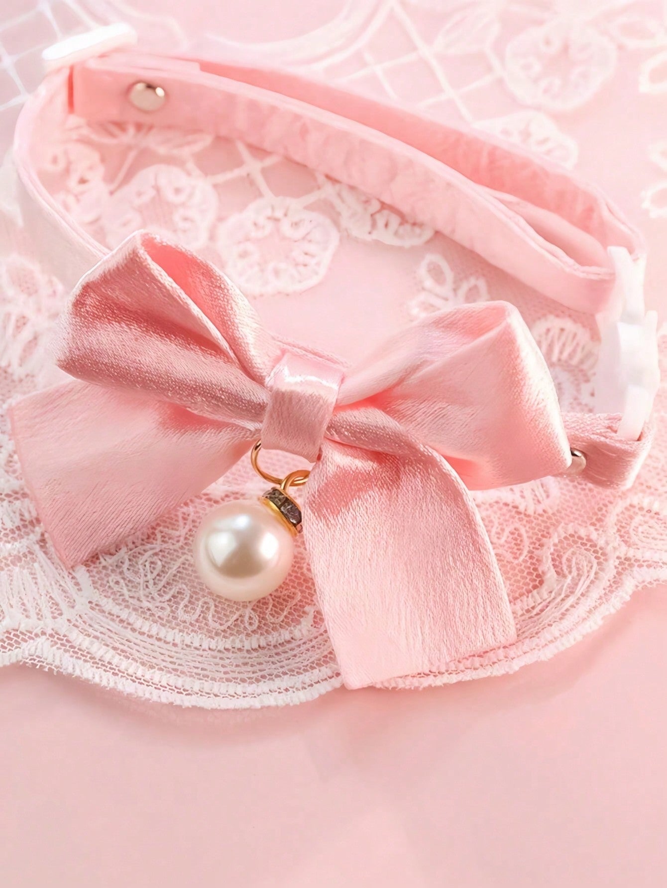 Pink floral breakaway cat collar with bow, pearls, and lace-style details for an adjustable kitten or girl cat collar.