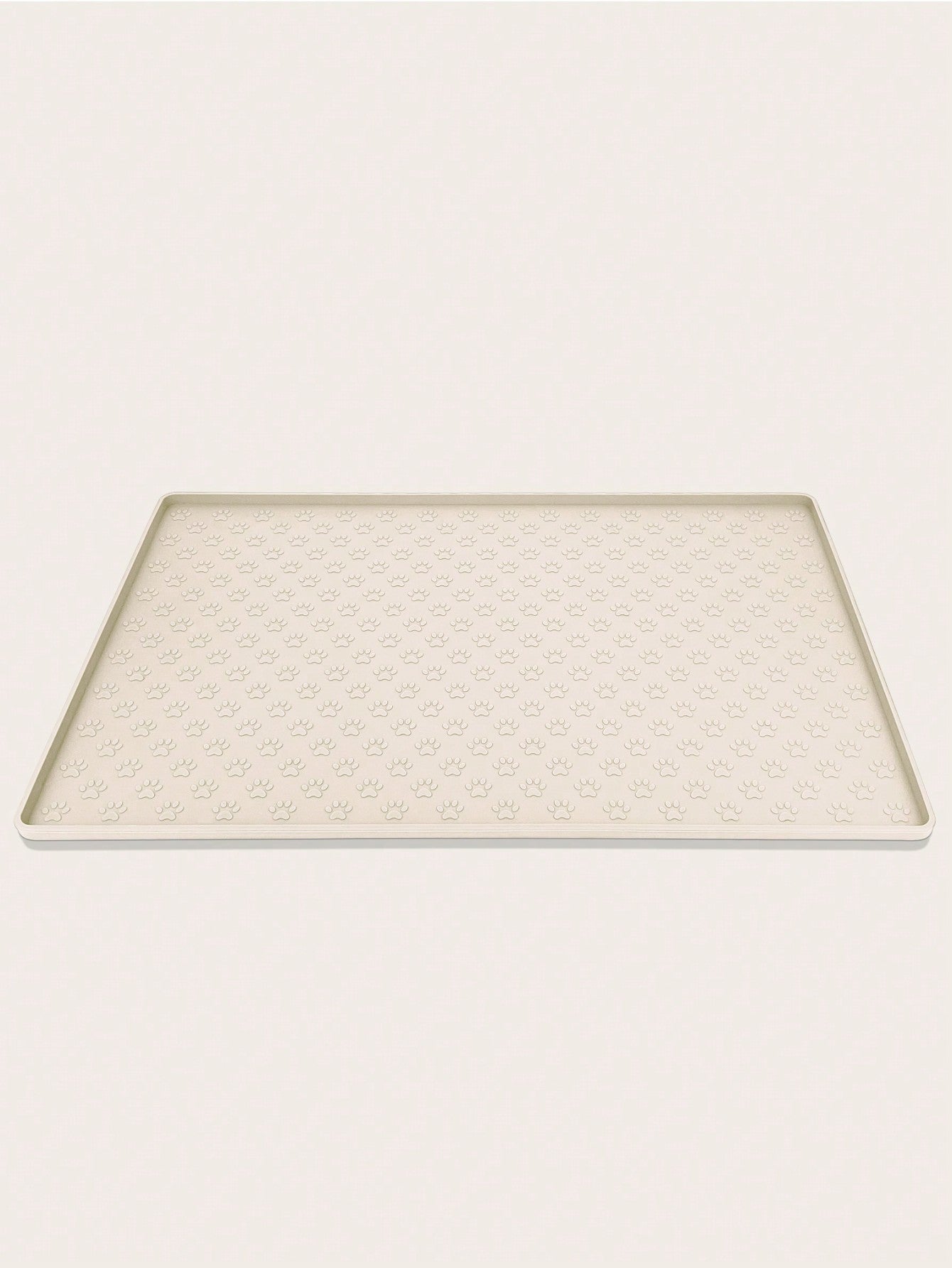 Beige silicone pet placemat with paw detail designed for cat and dog food and water bowls
