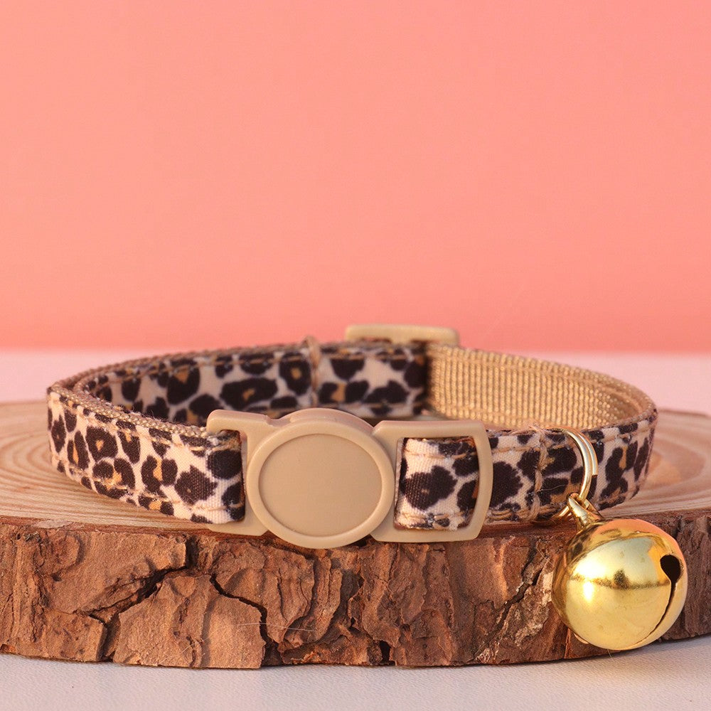 Leopard print adjustable cat collar with golden bell for cats and small pets, made from multicolor polyester.