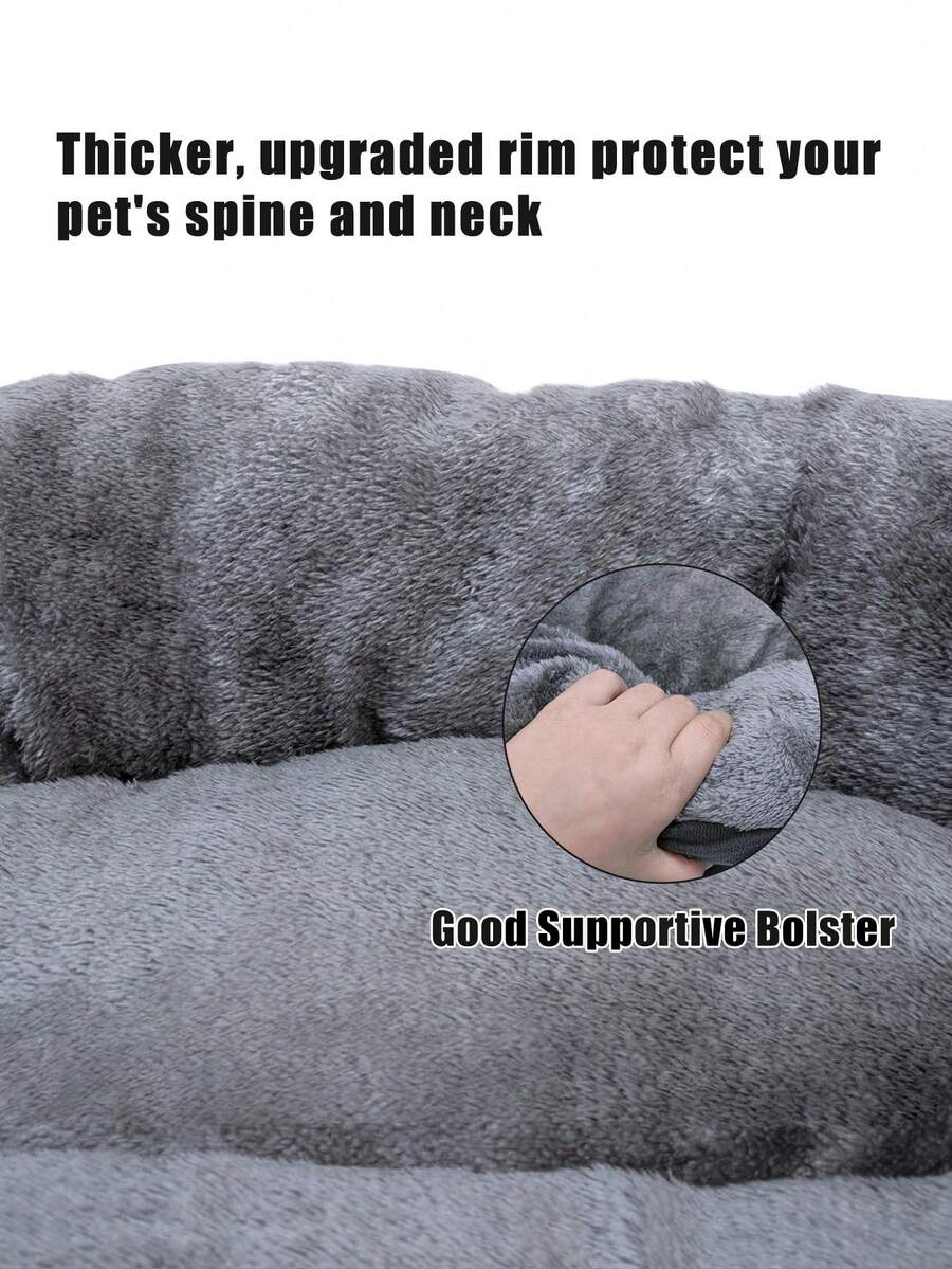 Dark grey plush donut calming pet bed for cats and dogs featuring a soft round design and non-slip bottom.