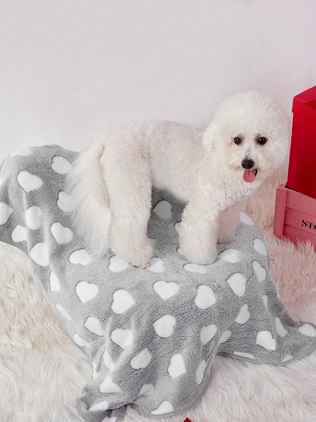 Soft warm pink paw print pattern pet blanket made of 100% polyester for cats and dogs.