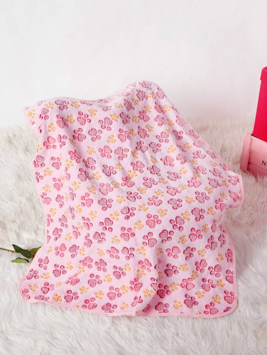 Soft warm pink paw print pattern pet blanket made of 100% polyester for cats and dogs.