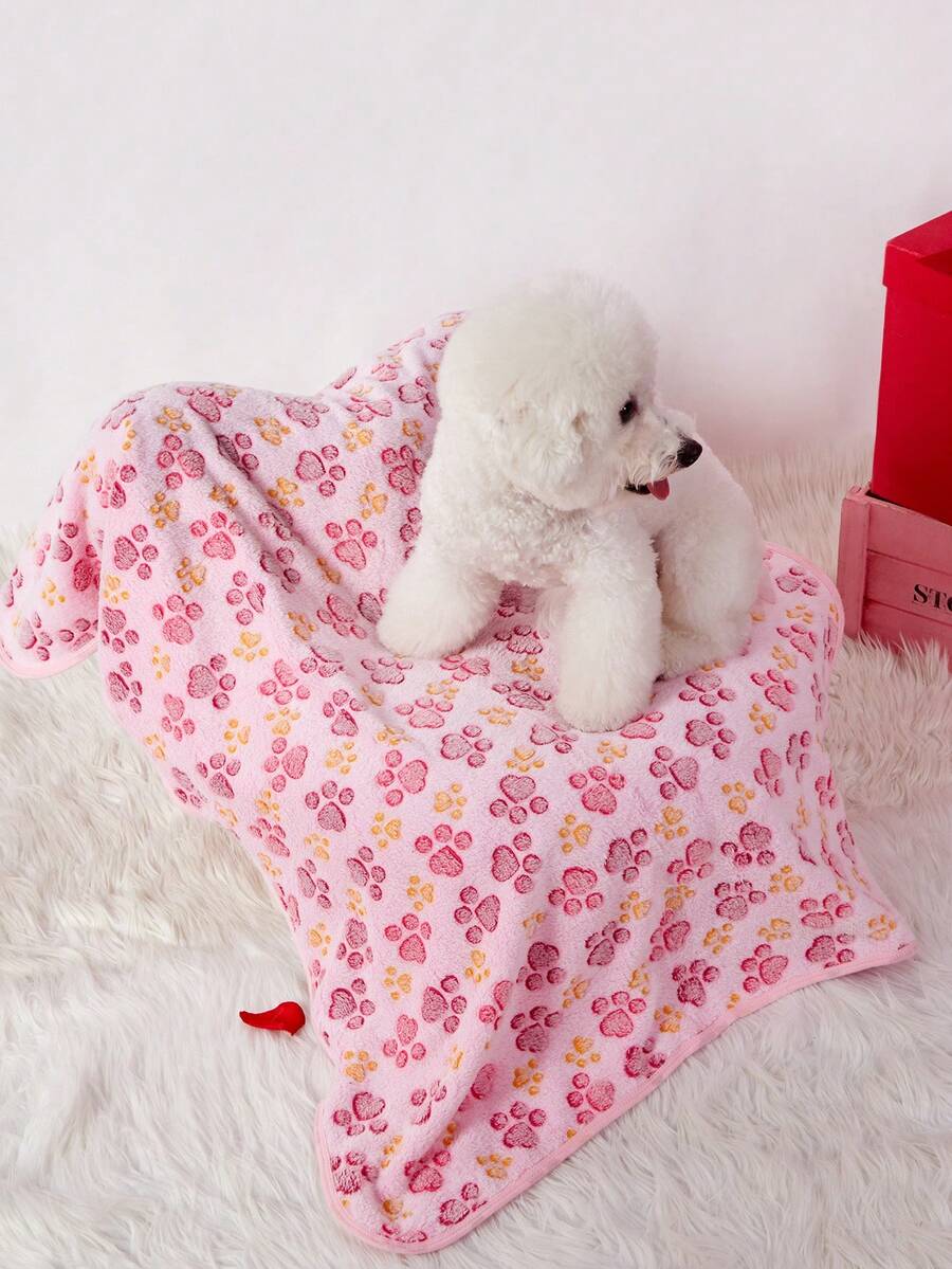 Soft warm pink paw print pattern pet blanket made of 100% polyester for cats and dogs.