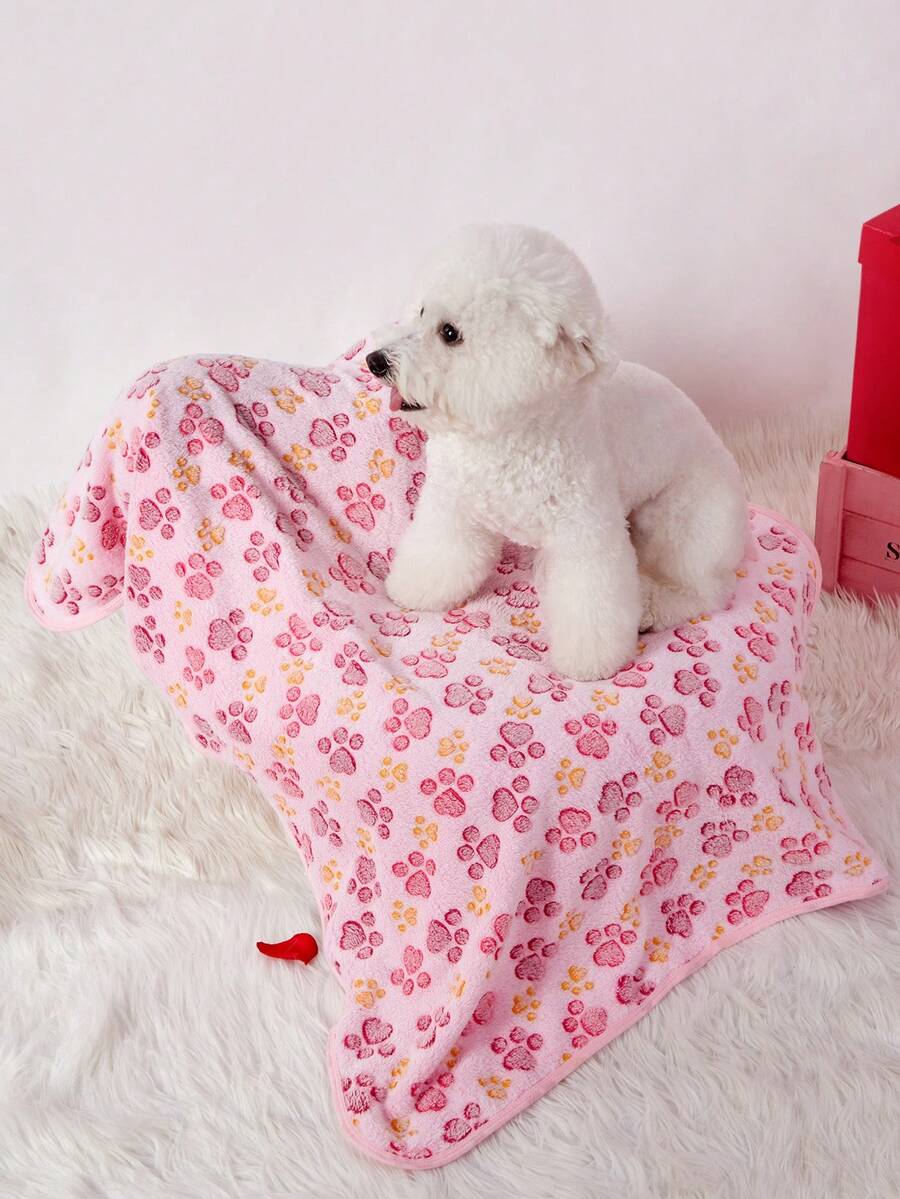 Soft warm pink paw print pattern pet blanket made of 100% polyester for cats and dogs.