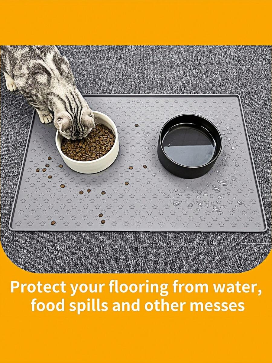 Black and white cartoon diatomite pet feeding mat placed under dog and cat food and water bowls to catch spills.