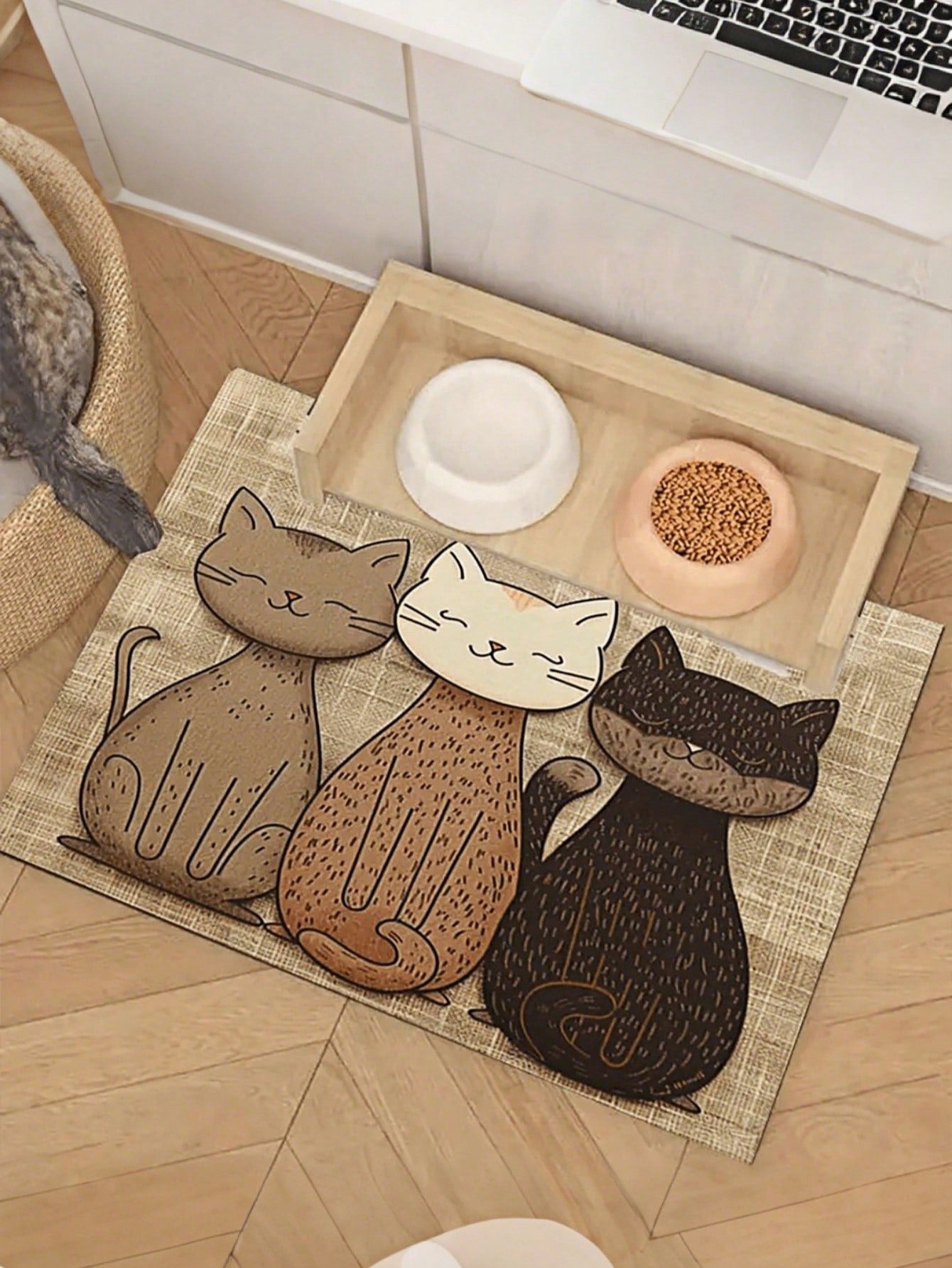 Multicolor geometric cats printed pet food mat with non-slip rubber backing placed under pet feeding bowls.