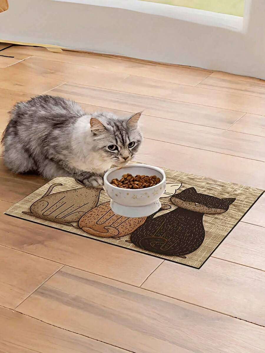 Multicolor geometric cats printed pet food mat with non-slip rubber backing placed under pet feeding bowls.