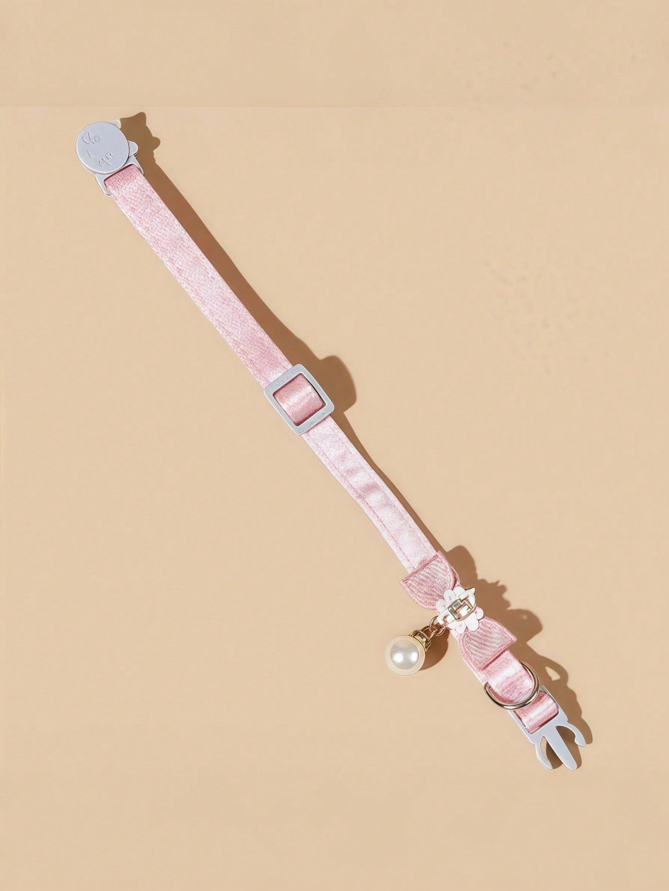 Baby pink adjustable polyester cat collar with quick release clasp, pearl pendant, white bead detail, bow, and flower decoration for kittens and cats.