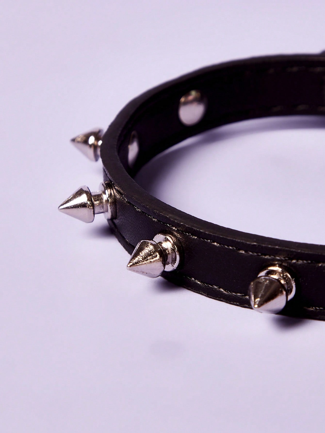 Black polyurethane pet collar with rivet decor and animal pattern styling for cats and dogs