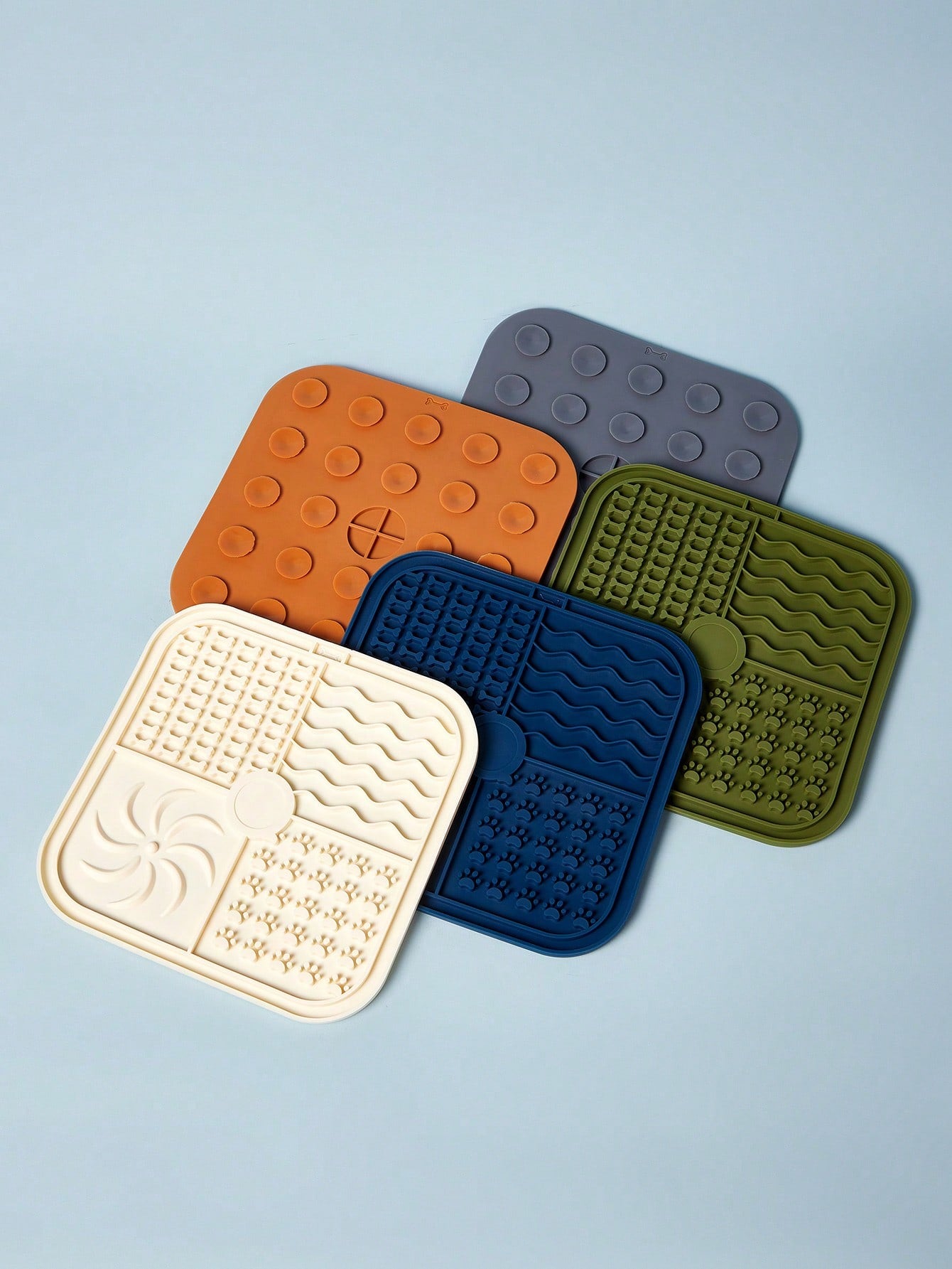 Multicolor square silicone dog lick mat featuring textured slow feeder patterns and suction cups.