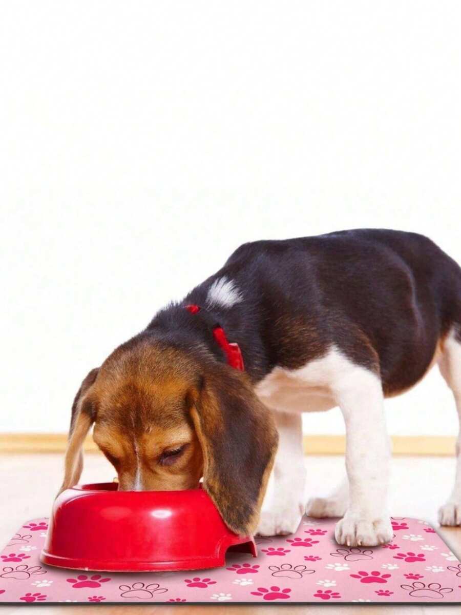 Black and white cartoon diatomite pet feeding mat placed under dog and cat food and water bowls to catch spills.
