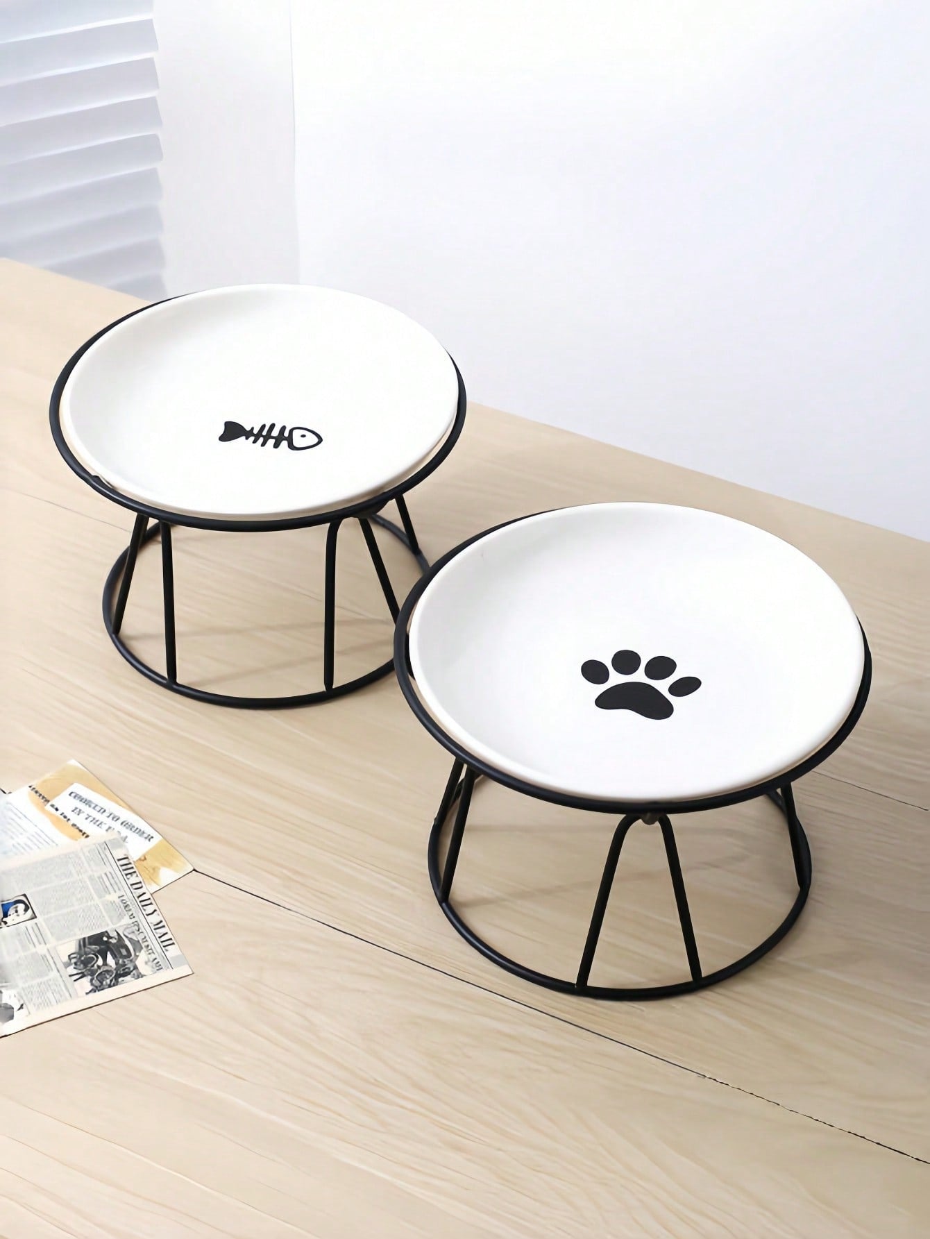 White elevated ceramic pet bowl set with non-slip stand featuring cat paw and fishbone designs