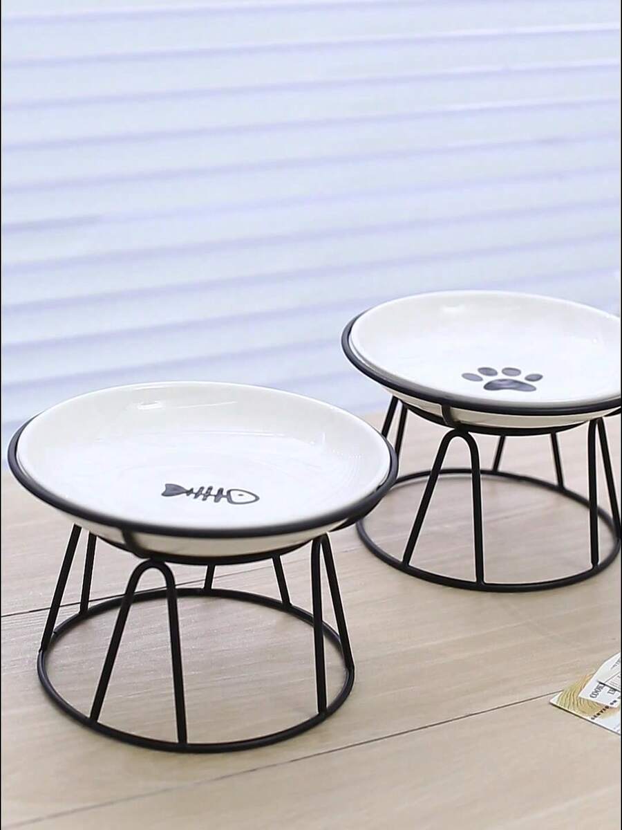 White elevated ceramic pet bowl set with non-slip stand featuring cat paw and fishbone designs