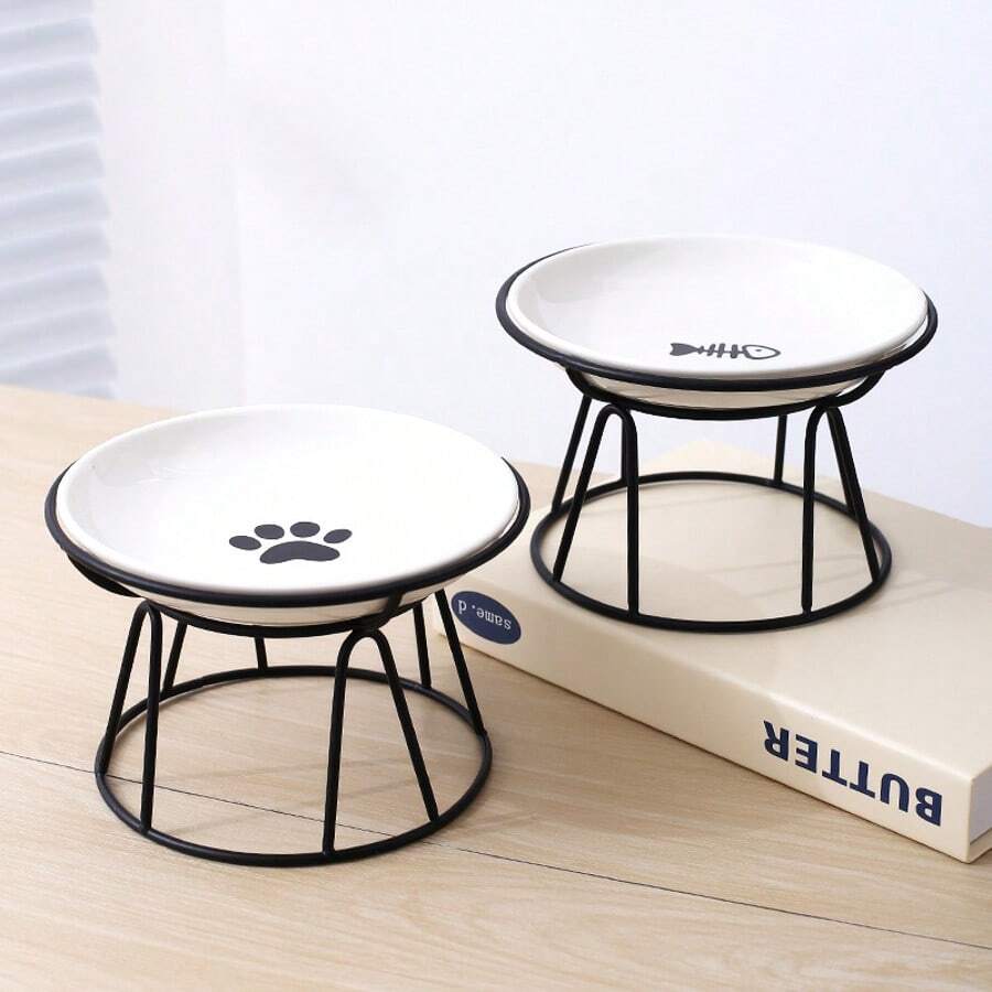 White elevated ceramic pet bowl set with non-slip stand featuring cat paw and fishbone designs