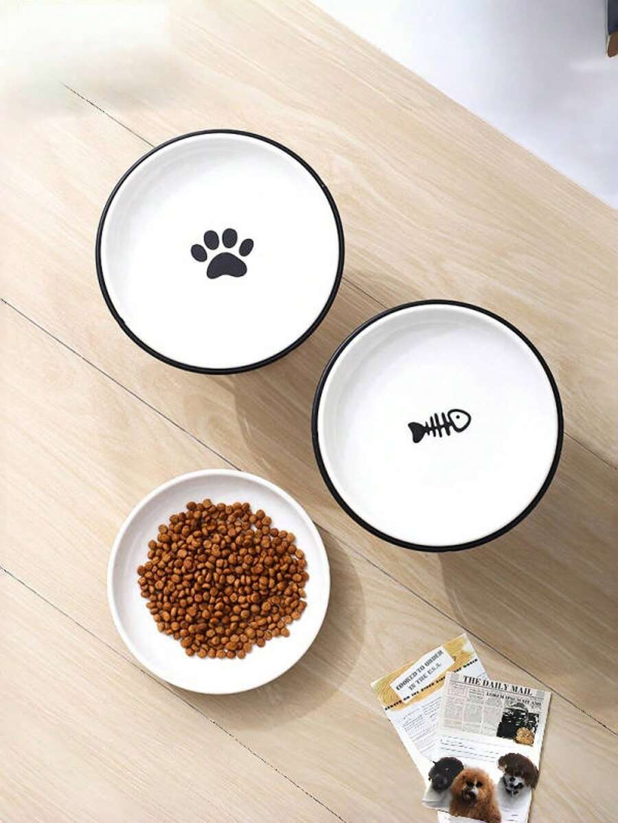 White elevated ceramic pet bowl set with non-slip stand featuring cat paw and fishbone designs