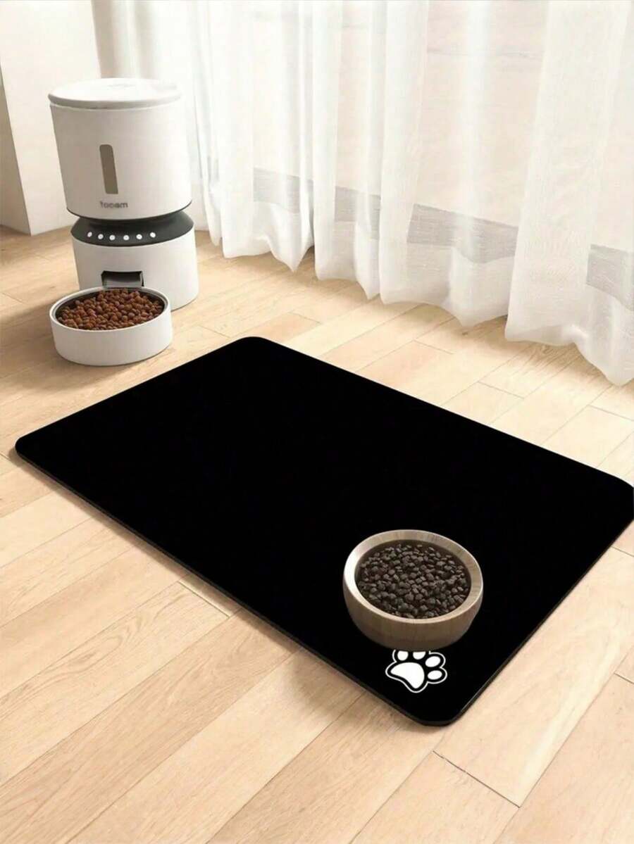 Black and white cartoon diatomite pet feeding mat placed under dog and cat food and water bowls to catch spills.