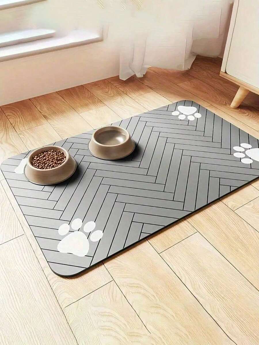 Black and white cartoon diatomite pet feeding mat placed under dog and cat food and water bowls to catch spills.
