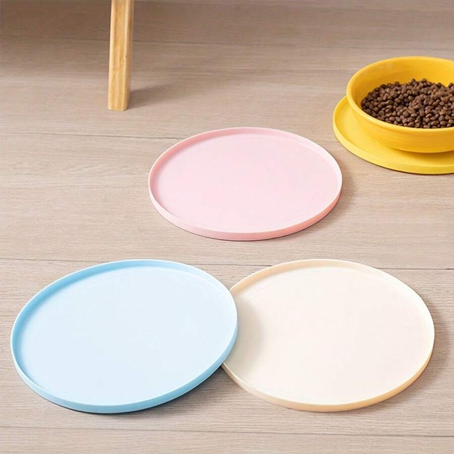 Round multicolor silicone pet food mat with raised edges for cats and dogs.