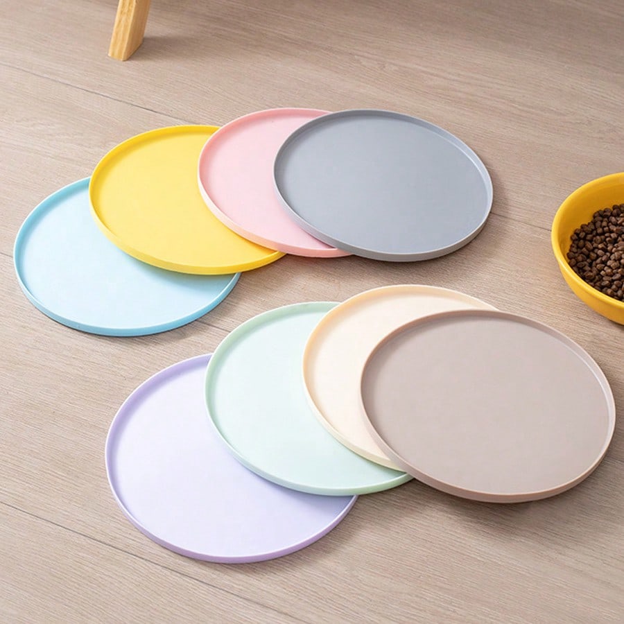 Round multicolor silicone pet food mat with raised edges for cats and dogs.