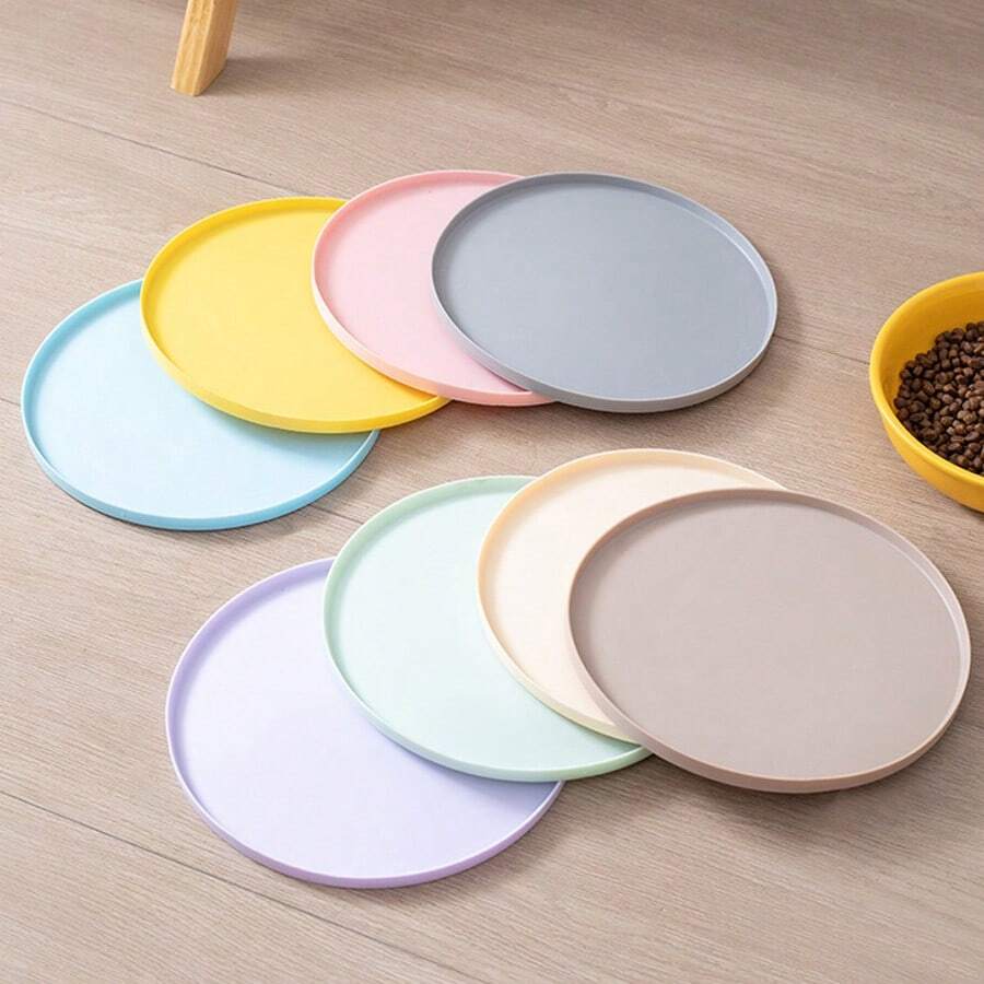 Round multicolor silicone pet food mat with raised edges for cats and dogs.