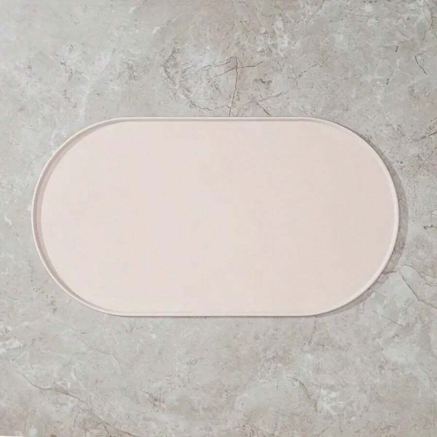 Beige oval silicone pet food mat with anti-slip and waterproof design for cat and dog bowls