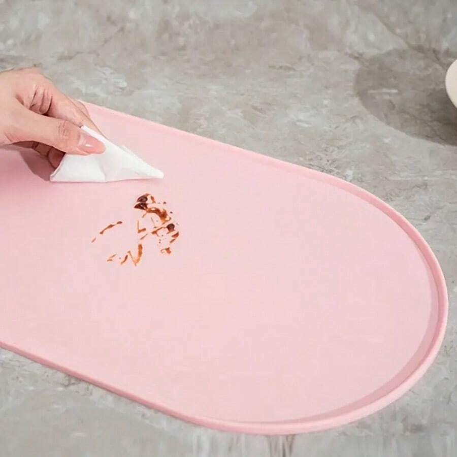 Beige oval silicone pet food mat with anti-slip and waterproof design for cat and dog bowls