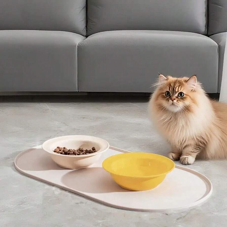Beige oval silicone pet food mat with anti-slip and waterproof design for cat and dog bowls