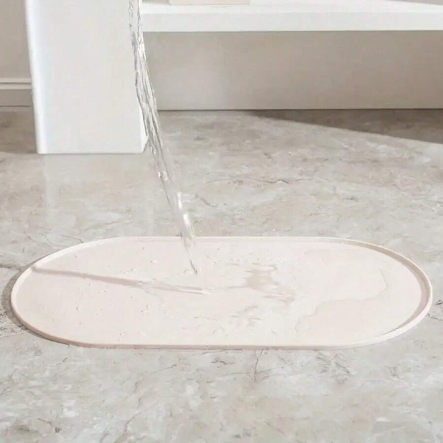 Beige oval silicone pet food mat with anti-slip and waterproof design for cat and dog bowls