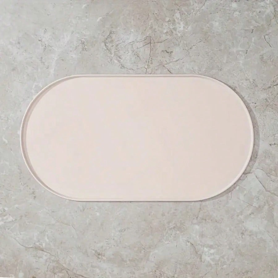 Beige oval silicone pet food mat with anti-slip and waterproof design for cat and dog bowls