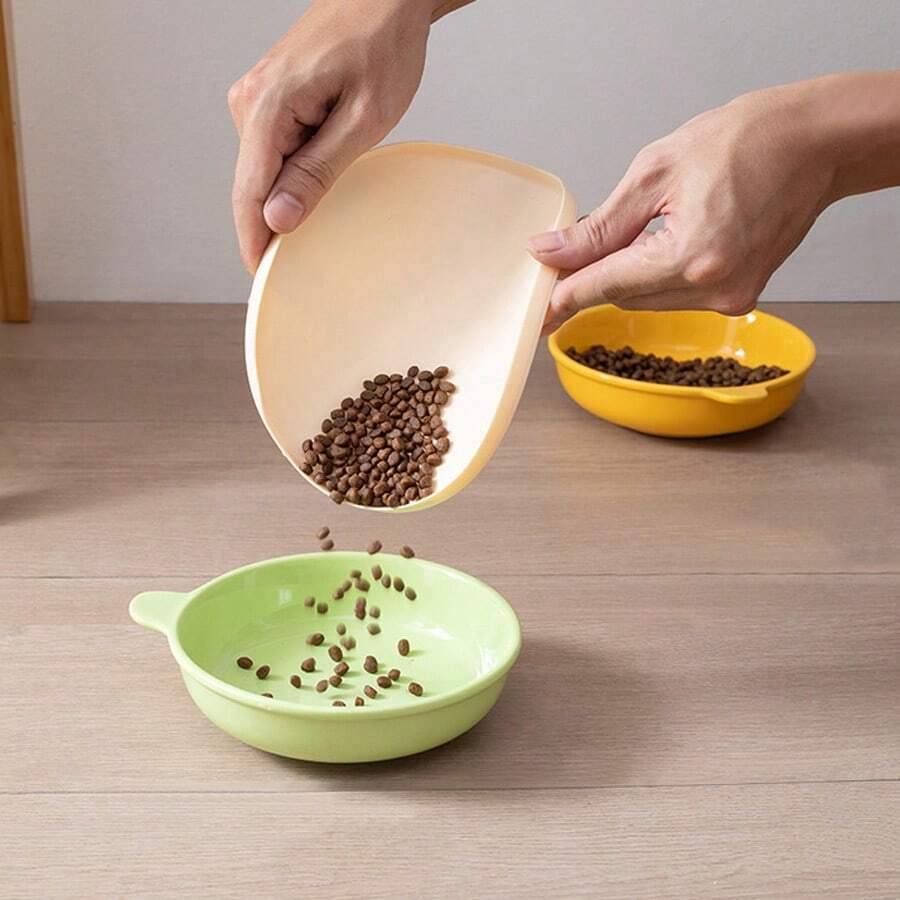Round multicolor silicone pet food mat with raised edges for cats and dogs.