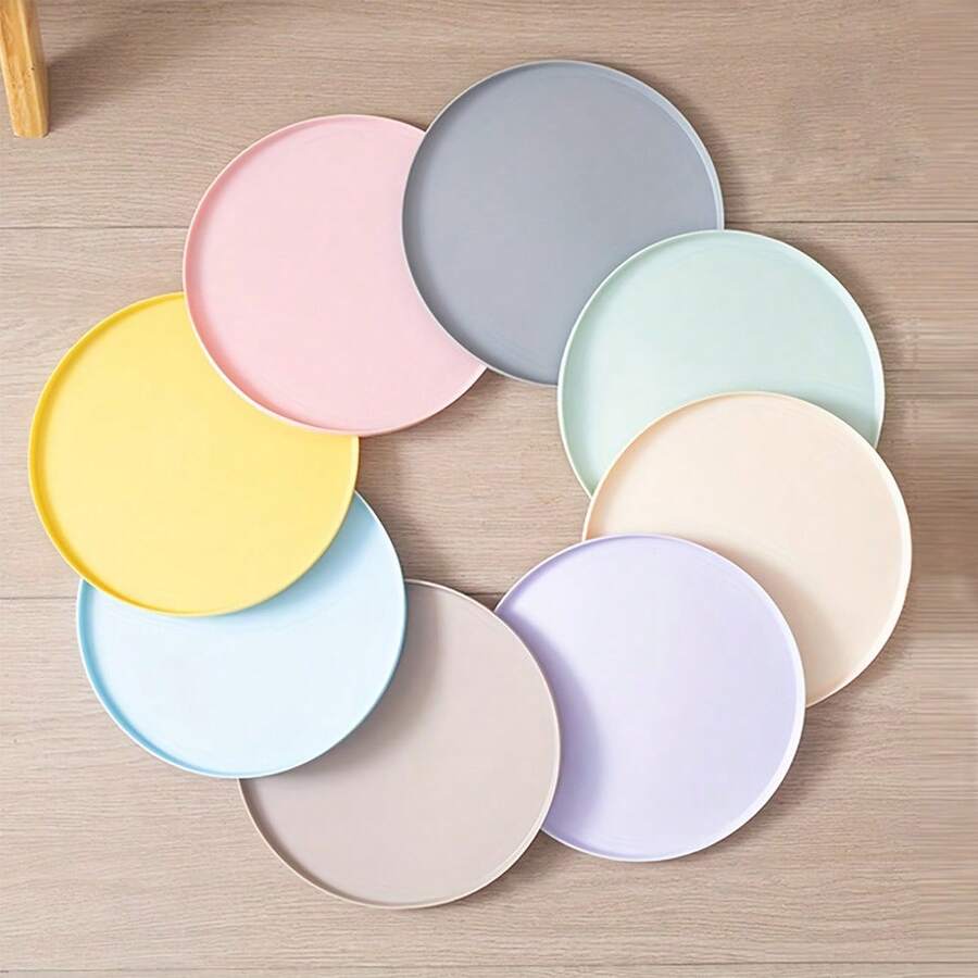 Round multicolor silicone pet food mat with raised edges for cats and dogs.